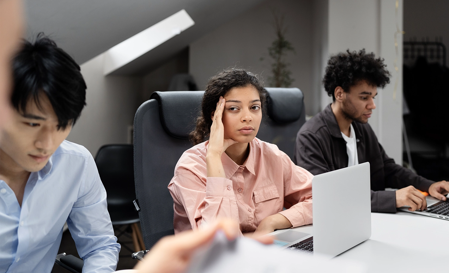 Exhausted employee experiencing burnout while managing an overwhelming workload at the office.
