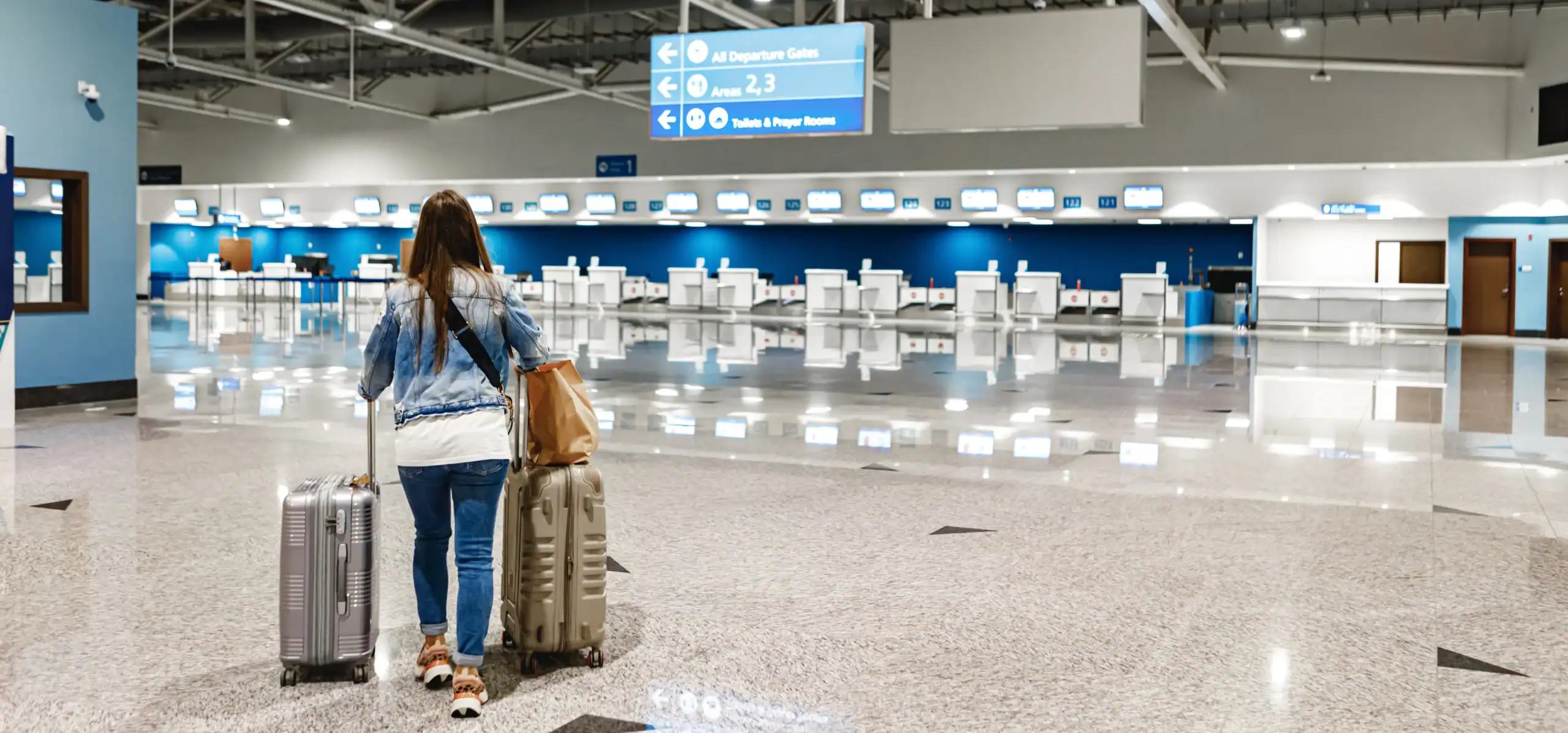 1woman-walks-along-airport-with-suitcases copy